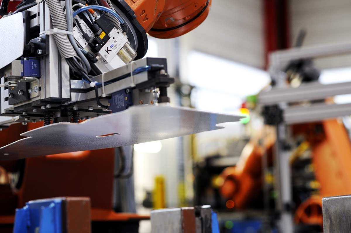 Robots manipulant des pièces d'acier pour l'industrie automobile